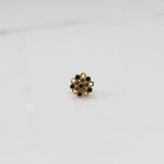 Front view of gold nose pin with green and pink gemstone mandala design on white background