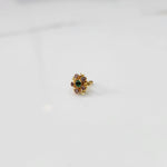 Gold statement ring with green and pink gemstones in floral cluster setting
