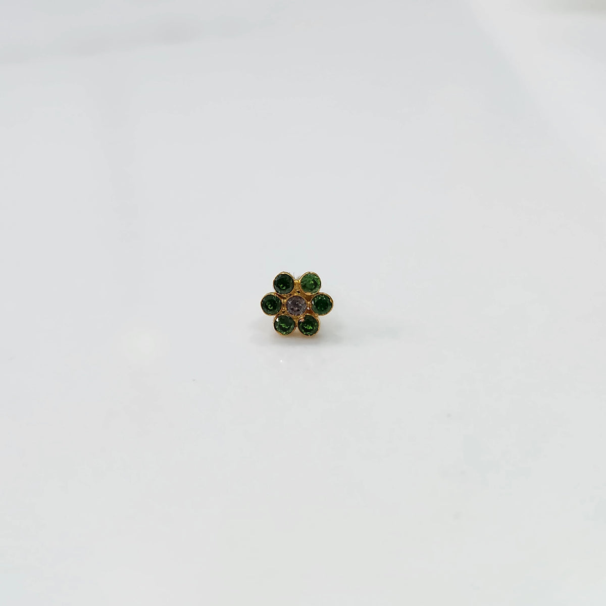 Nose pin design gold green with stone floral pattern on white background
