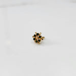 Gold statement ring with green gemstones in scattered dotted cluster design