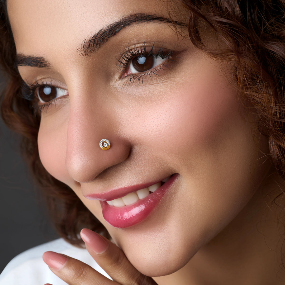Woman wearing a halo-style gold nose pin
