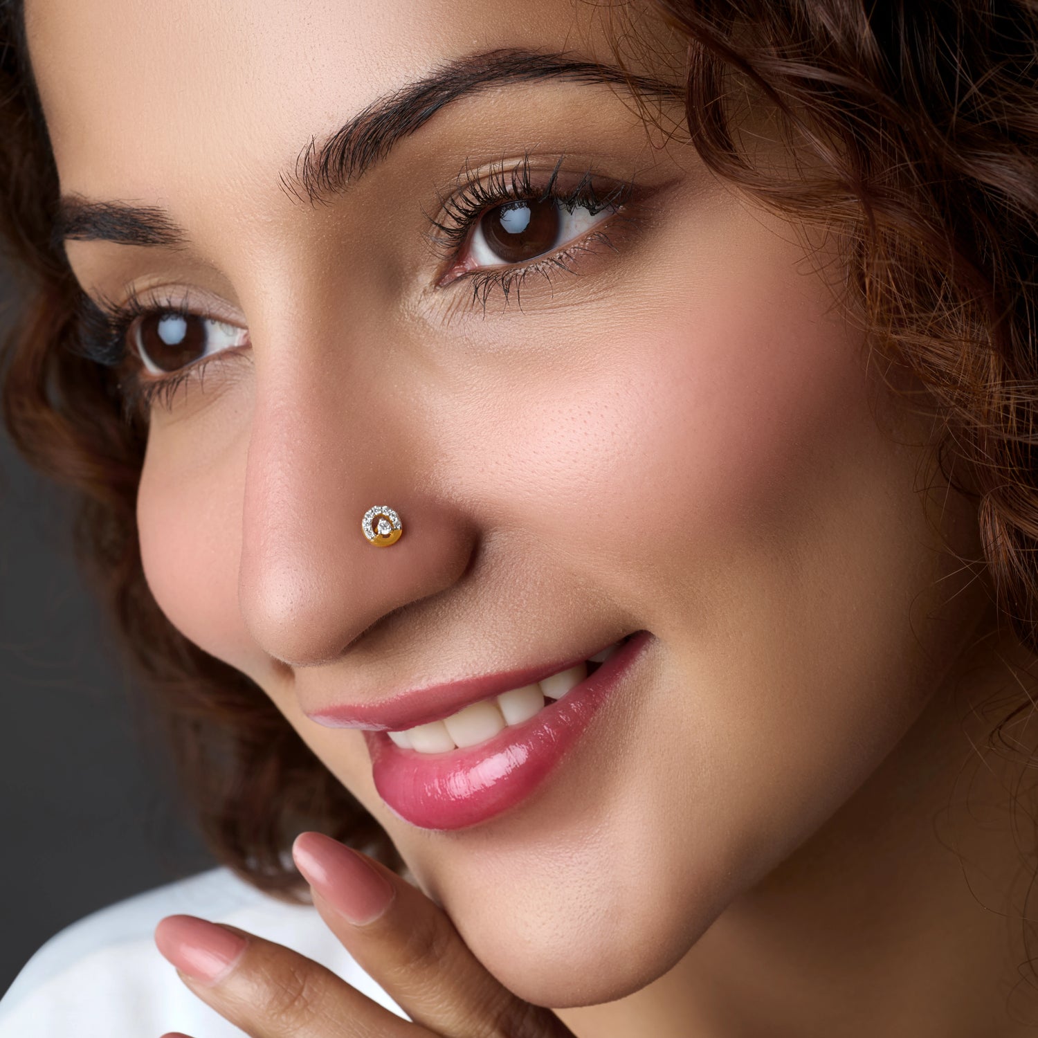 Woman wearing a halo-style gold nose pin