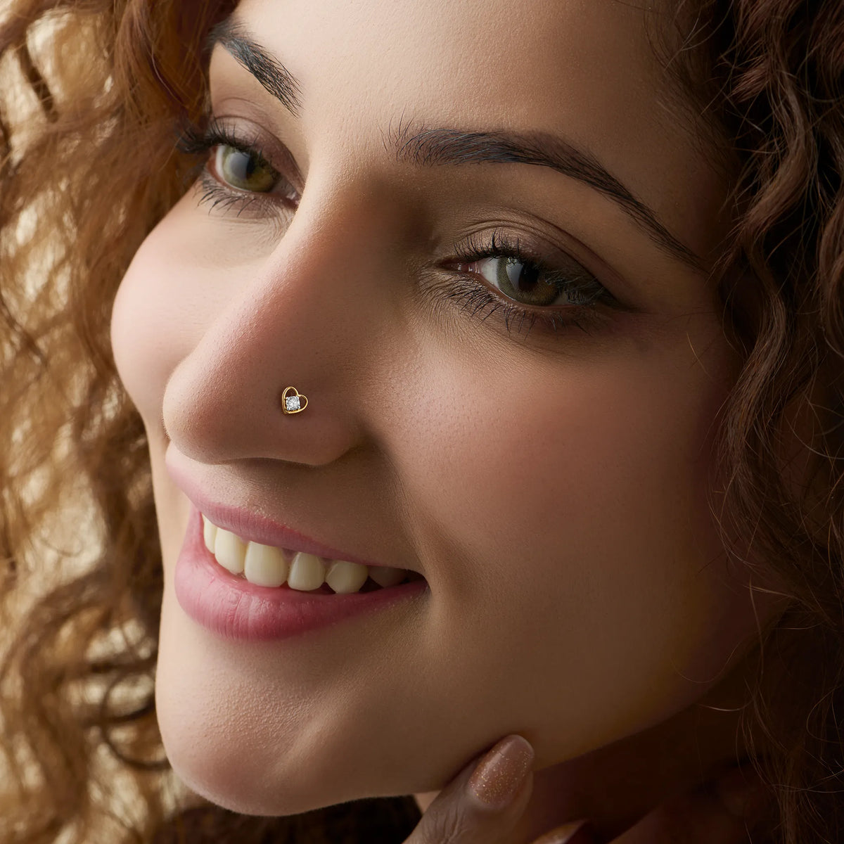 Elegant gold nose pin with heart-accent diamond detail, jewelry close-up