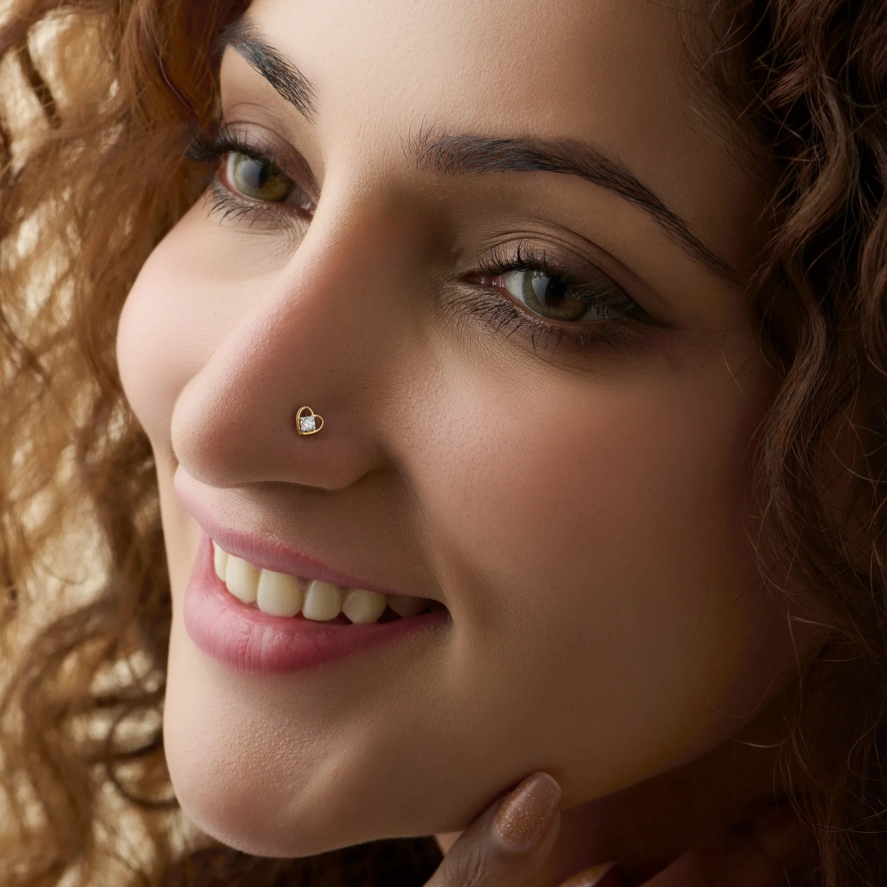 Elegant gold nose pin with heart-accent diamond detail, jewelry close-up
