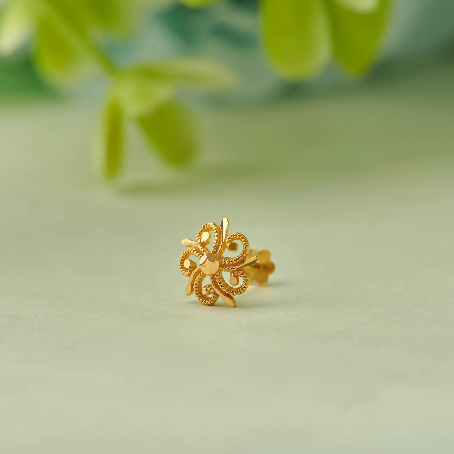 Gold flower-shaped stud earring with heart-petal design