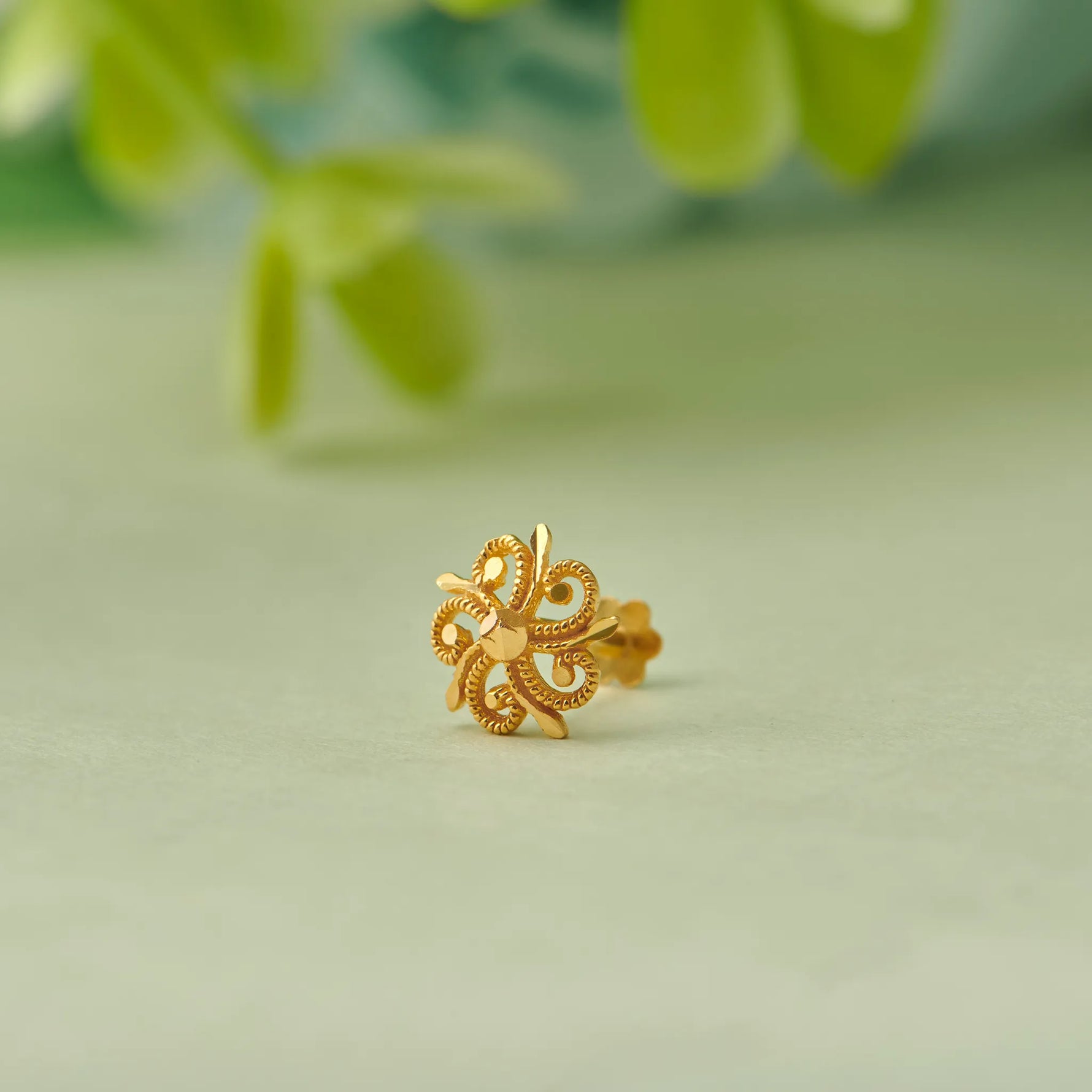 Gold flower-shaped stud earring with heart-petal design