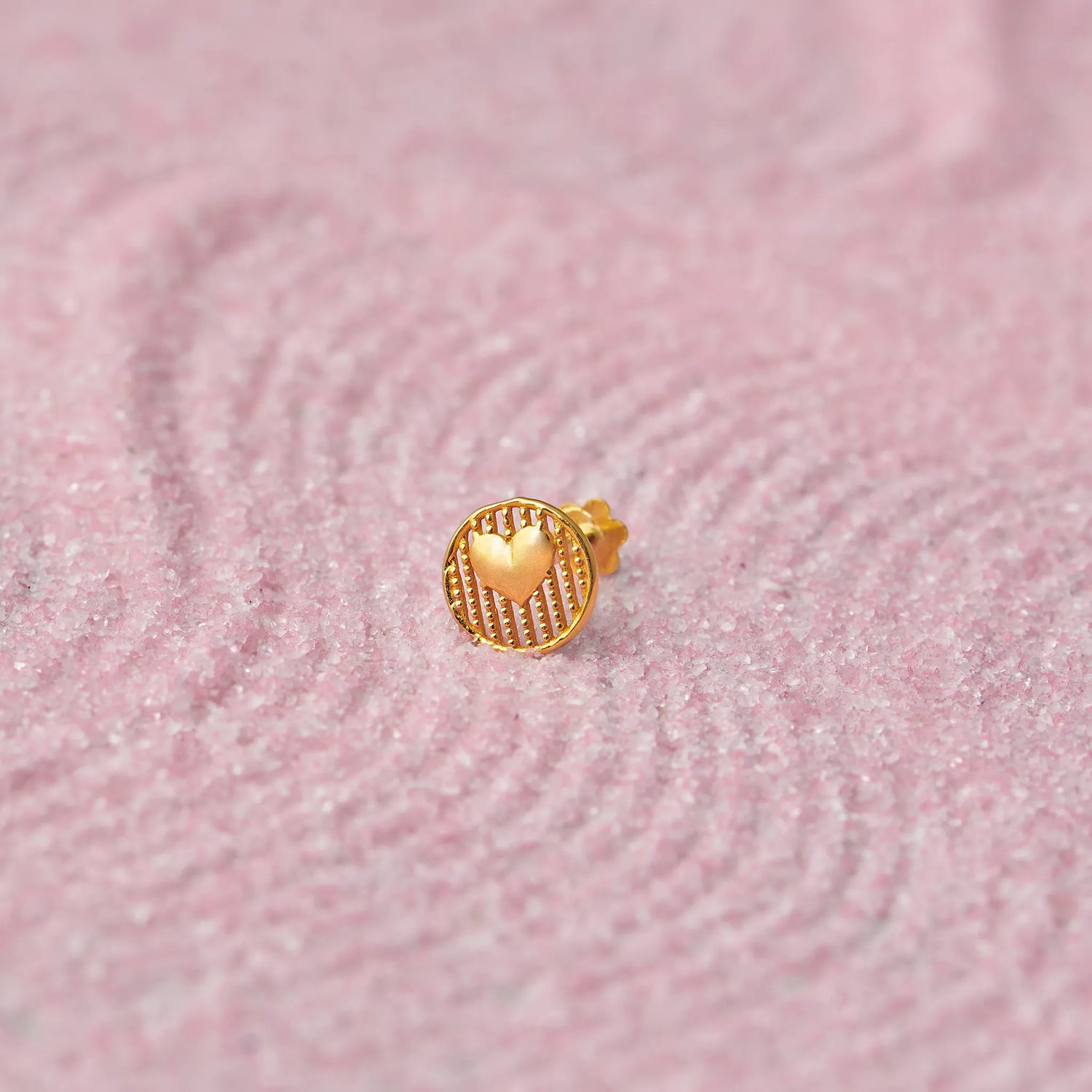 Gold heart medallion stud earring with ridged border
