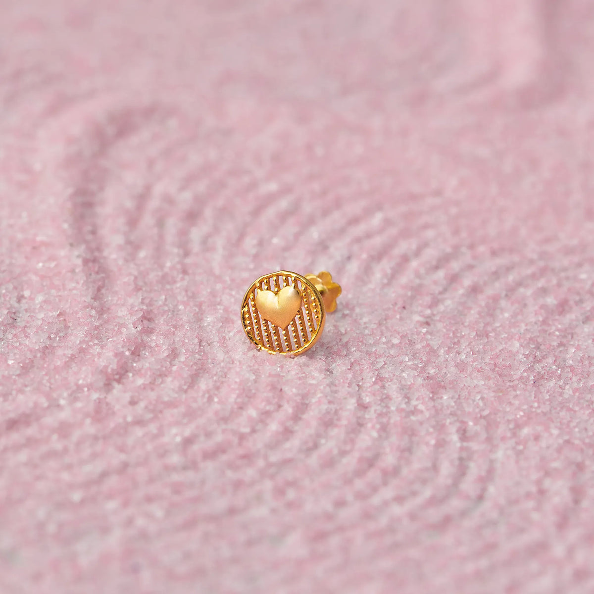 Gold heart medallion stud earring with ridged border