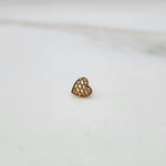 Close up of gold nose stud with woven heart design