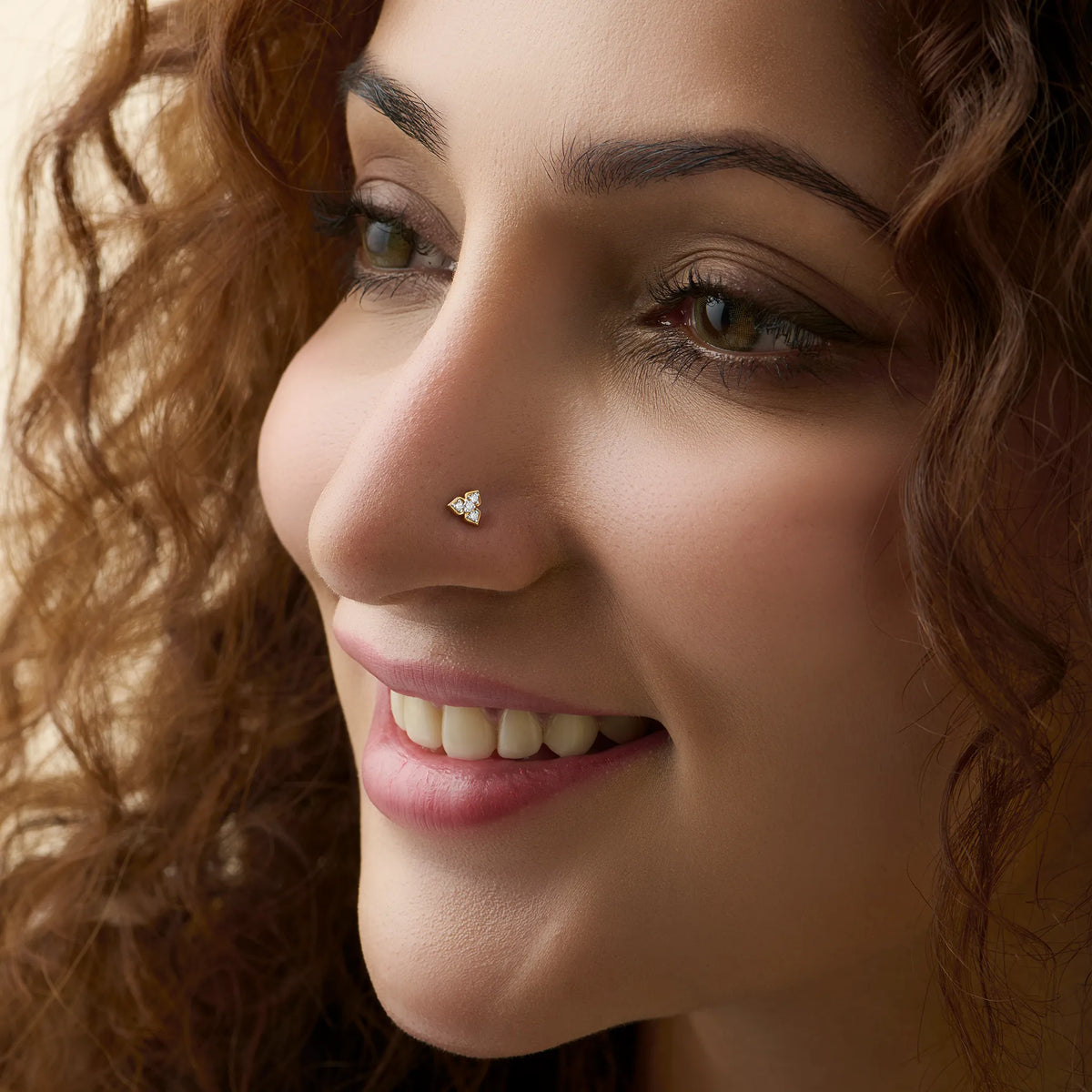 Woman wearing lab grown diamond nose pin with minimal diamond cluster style