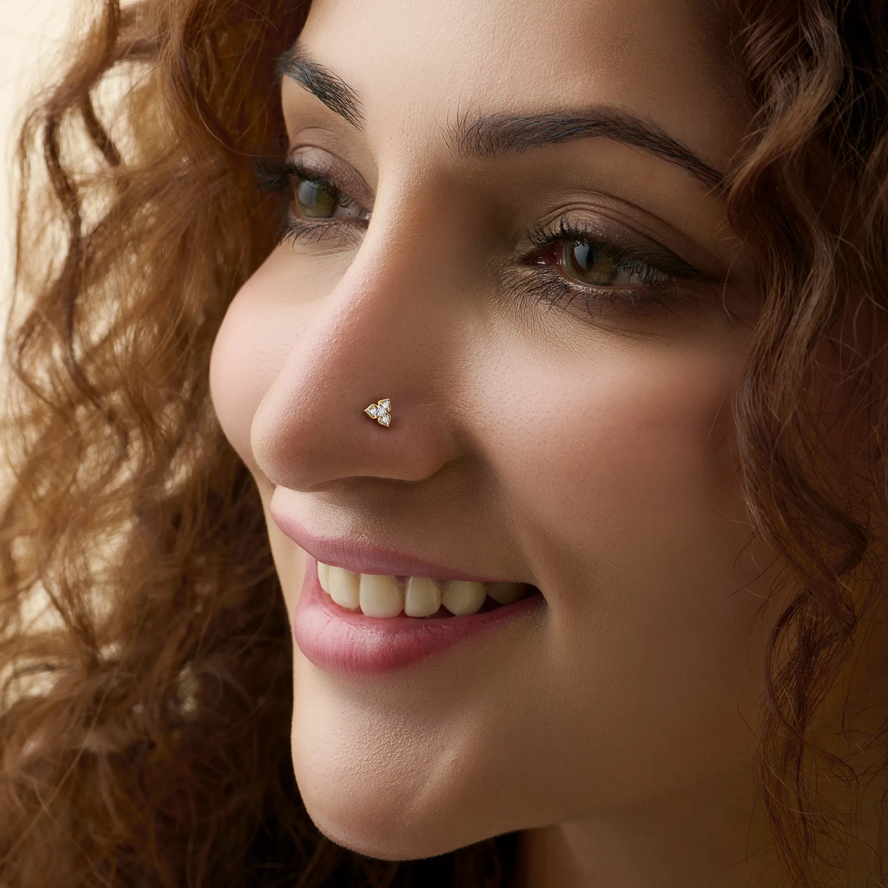 Woman wearing lab grown diamond nose pin with minimal diamond cluster style