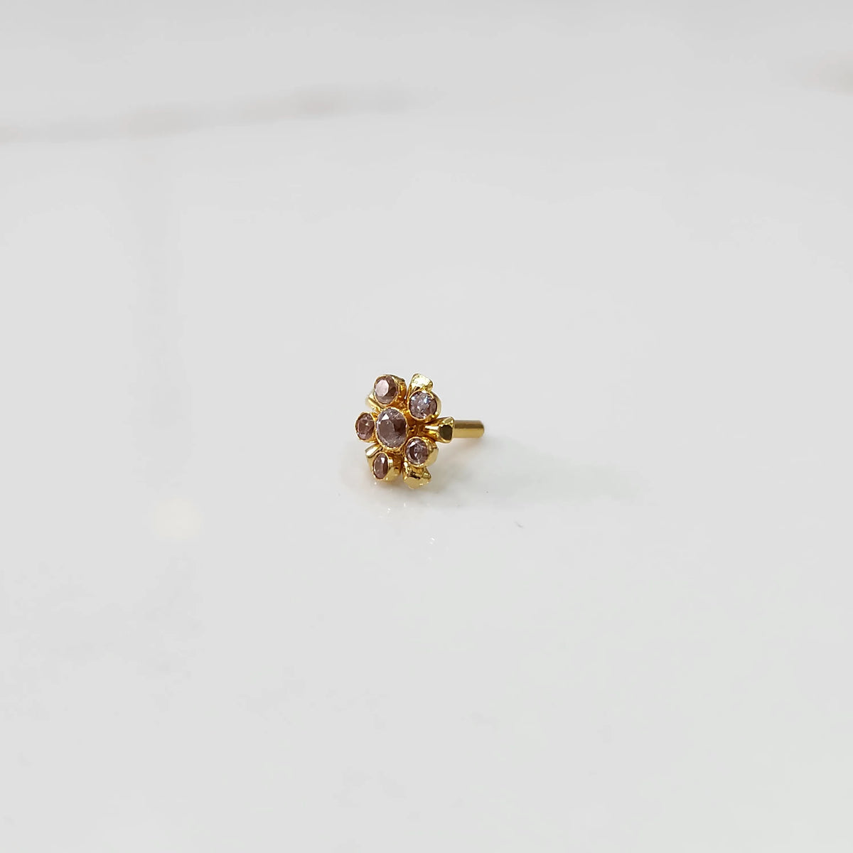 Gold floral nose pin with lavender stones, product shot
