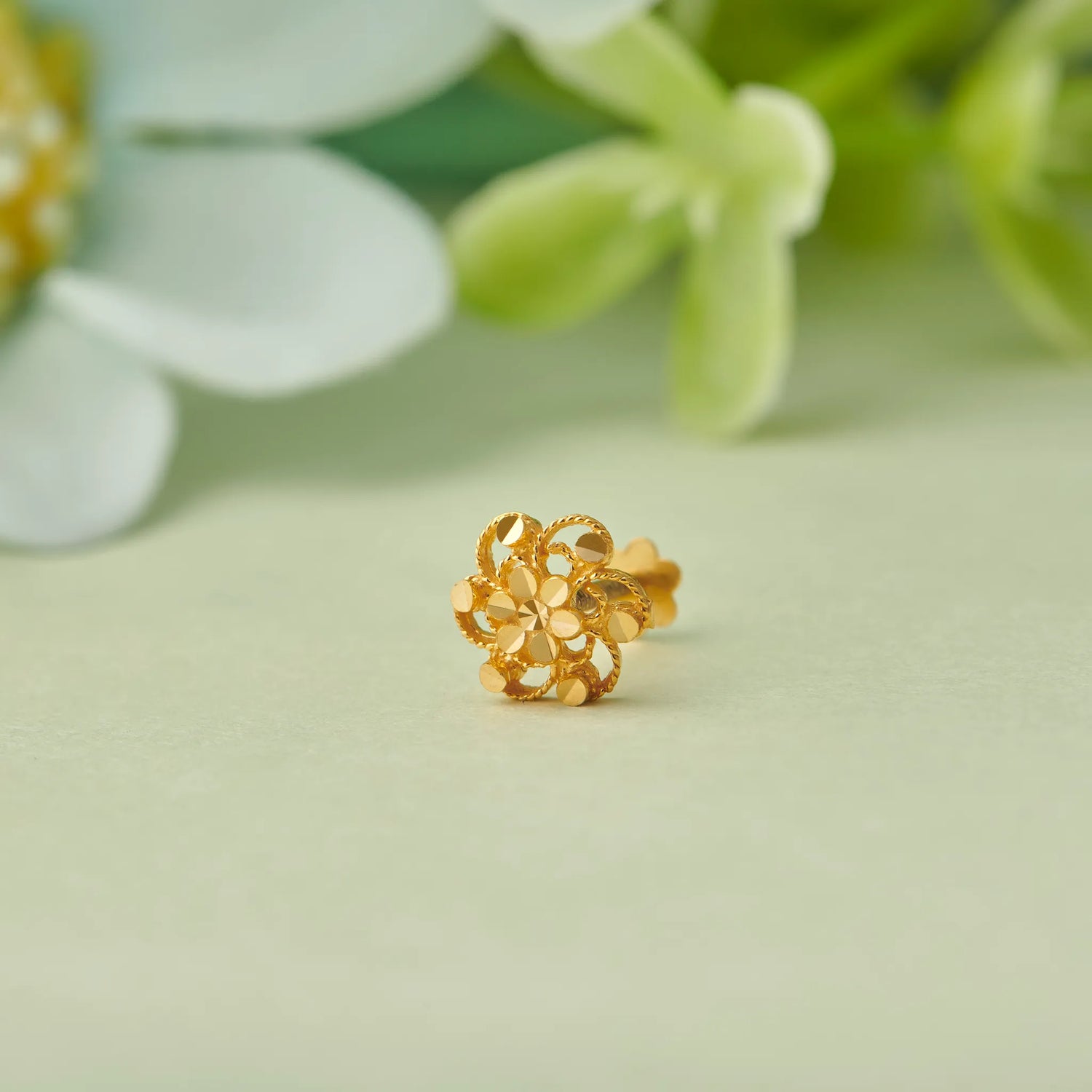 Gold flower-shaped stud earring with layered loop design