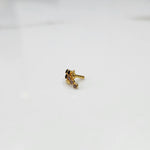 Gold ring with black and purple gemstone leaf-charm cluster design, side view