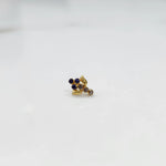 Antique-style gold ring with blue-toned stones in leaf-charm pattern