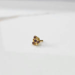 Antique-style gold ring with pink-toned stones in leaf-petal pattern, angled view