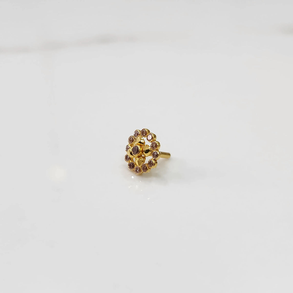 Gold round nose pin with light pink stone halo, product shot
