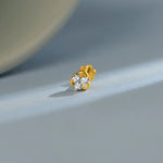 Gold floral diamond nose pin design on soft blue background