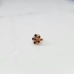 Gold nose pin with magenta gemstone mandala design on white background 
