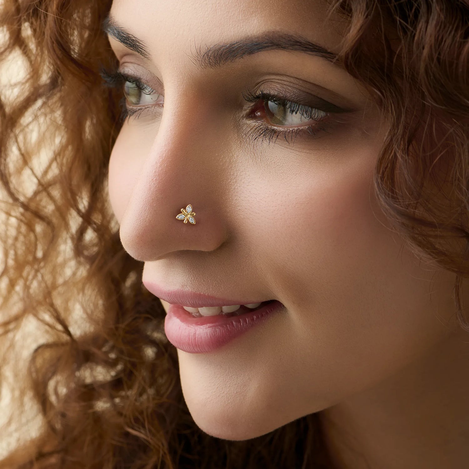 Model showcasing a delicate five-petal gold diamond nose pin