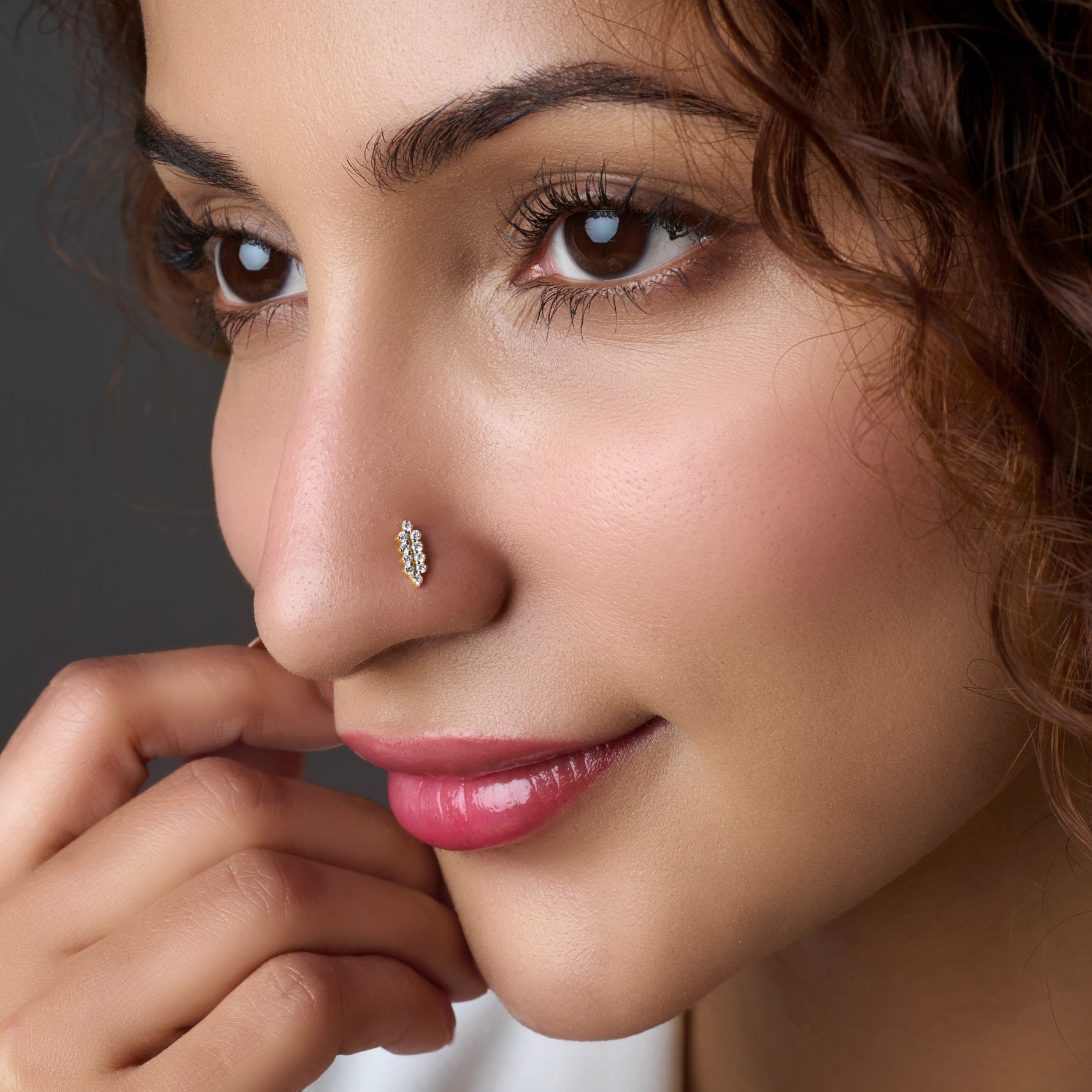 Close-up of elongated gold nose stud design
