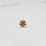 Gold flower-shaped ring with multicolored gemstones and pearl accents