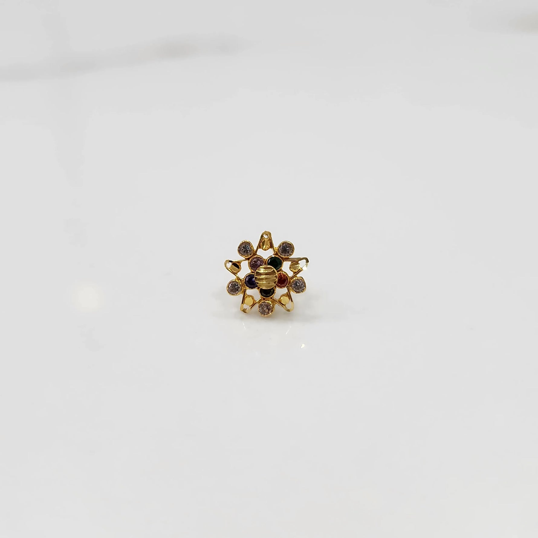 Gold flower-shaped ring with multicolored gemstones and pearl accents