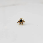 Gold ring with black round center stone and champagne accents