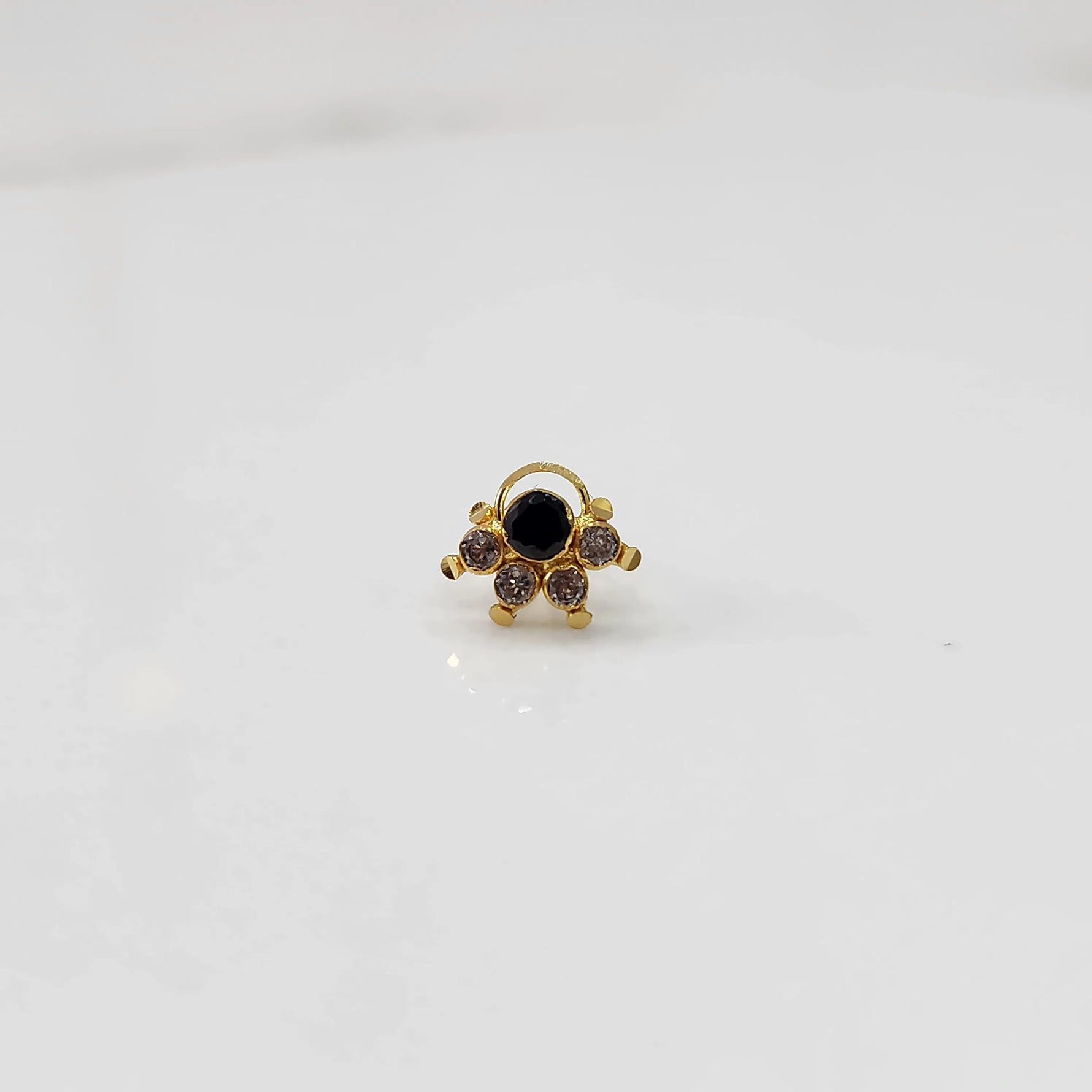 Gold ring with black round center stone and champagne accents