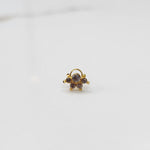 Traditional gold ring featuring an asymmetric five-stone gemstone design