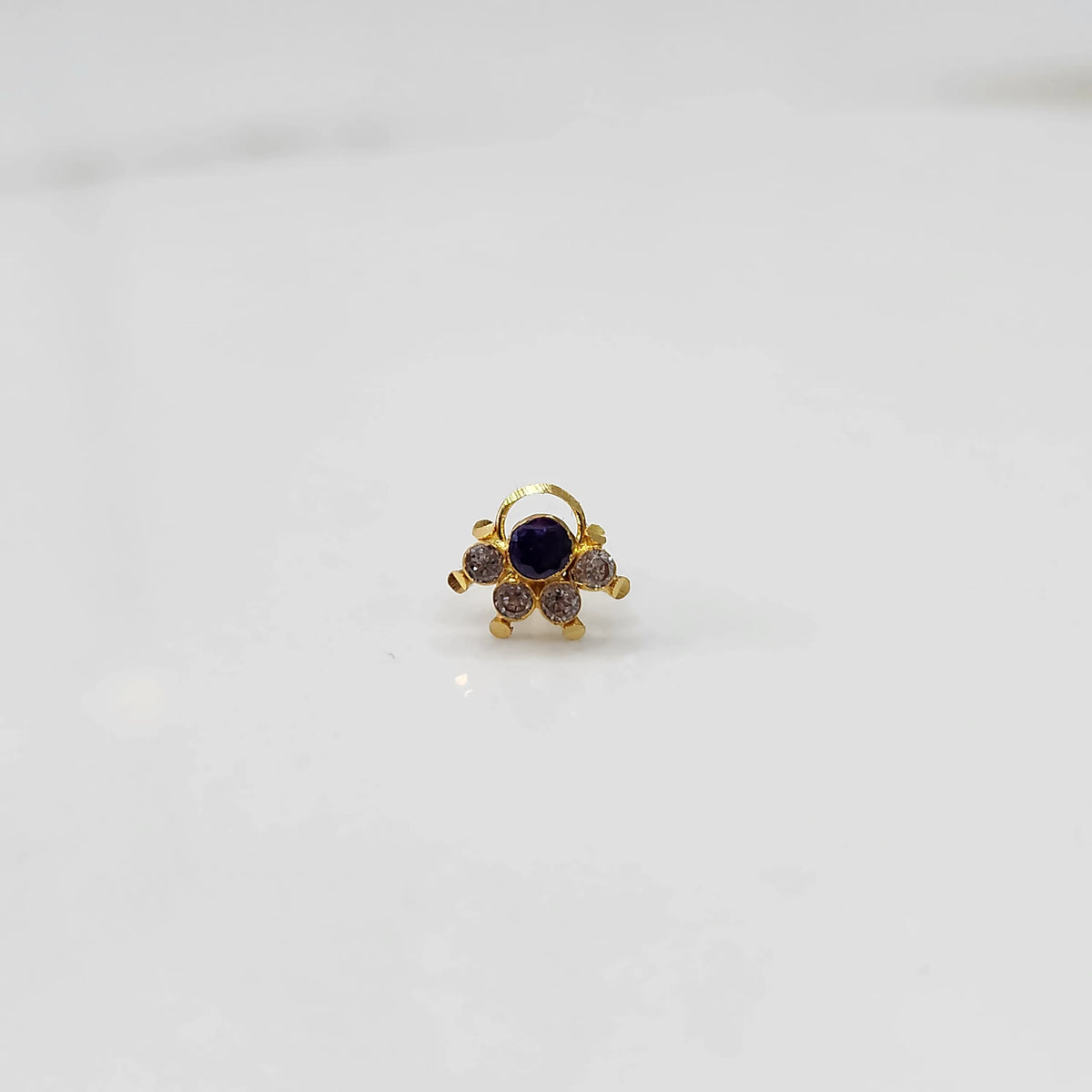 Close-up of gold multicolor cluster ring with purple and clear stones