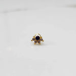 Close-up of gold multicolor cluster ring with purple and clear stones