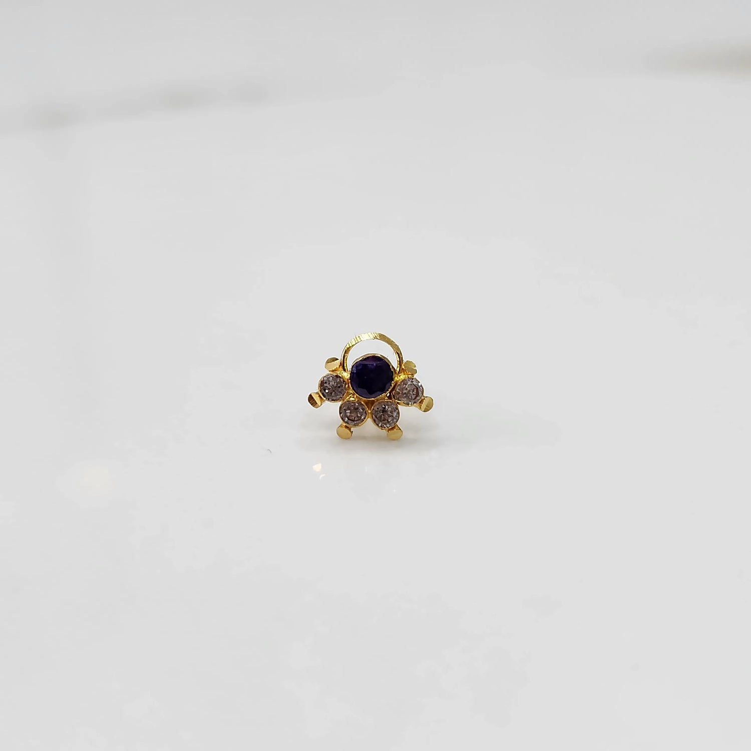 Close-up of gold multicolor cluster ring with purple and clear stones