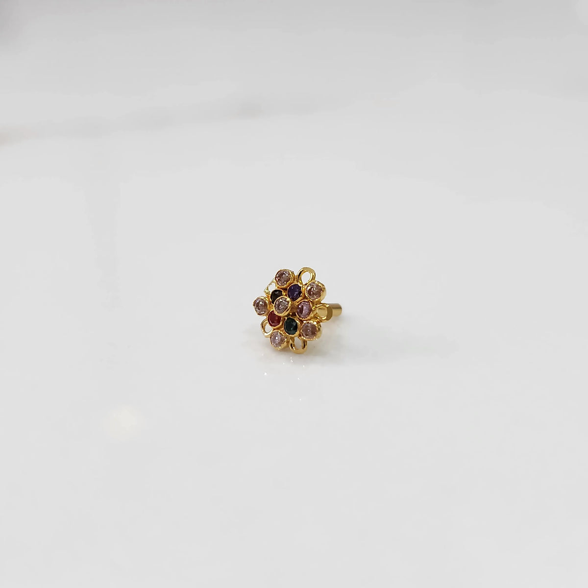 Gold nose pin with multicolor gemstone mandala design on white background