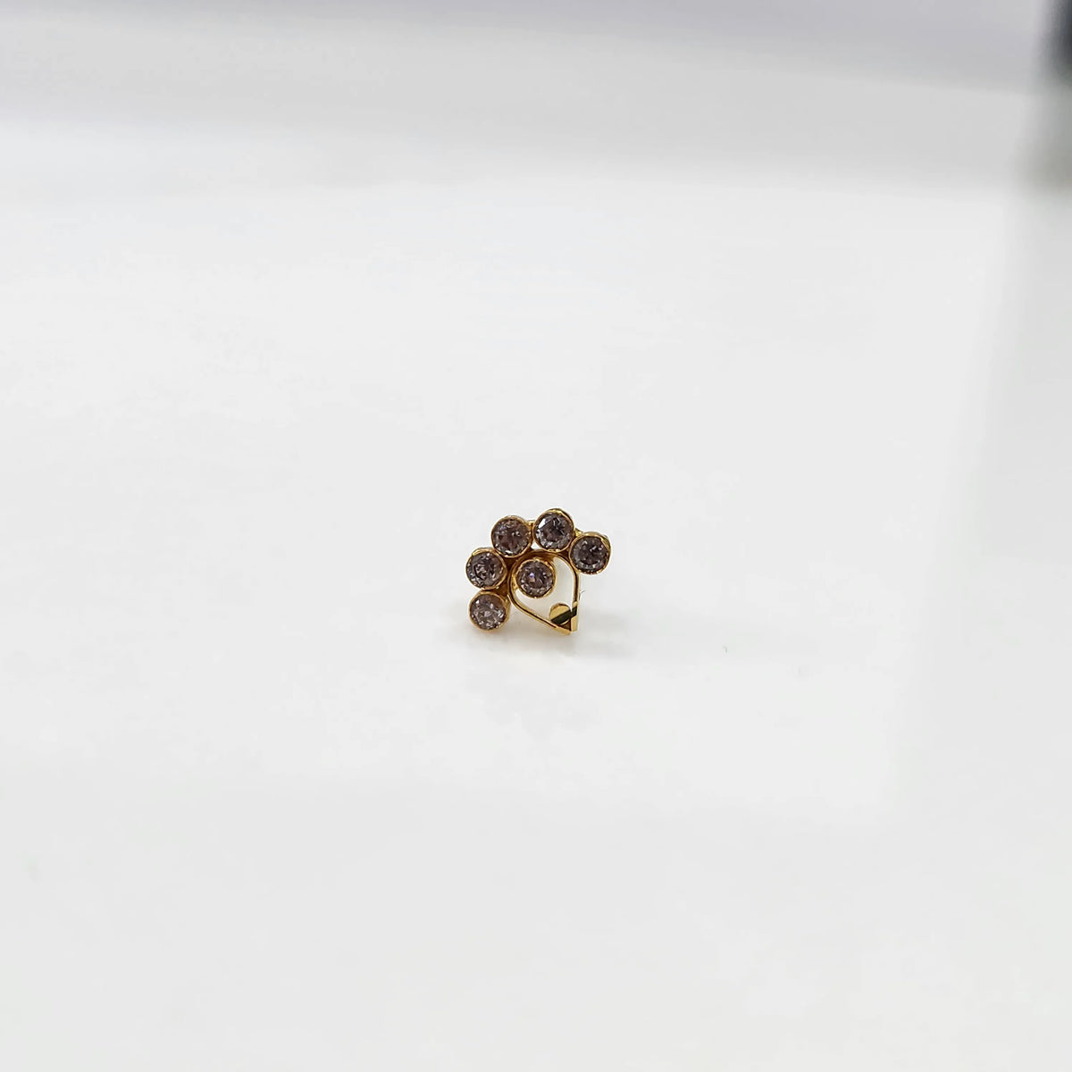 Front view of gold ring featuring purple floral gemstone petals