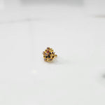 Gold statement ring with multicolor gemstones in dense flower cluster setting