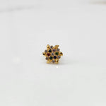 Front view of gold statement ring with multicolor gemstones in leaf-patterned cluster design