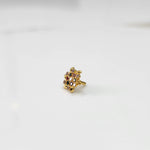 Gold statement ring with multicolor gemstones in leaf-patterned floral cluster design