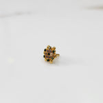 Gold statement ring with multicolor gemstones in round textured floral design