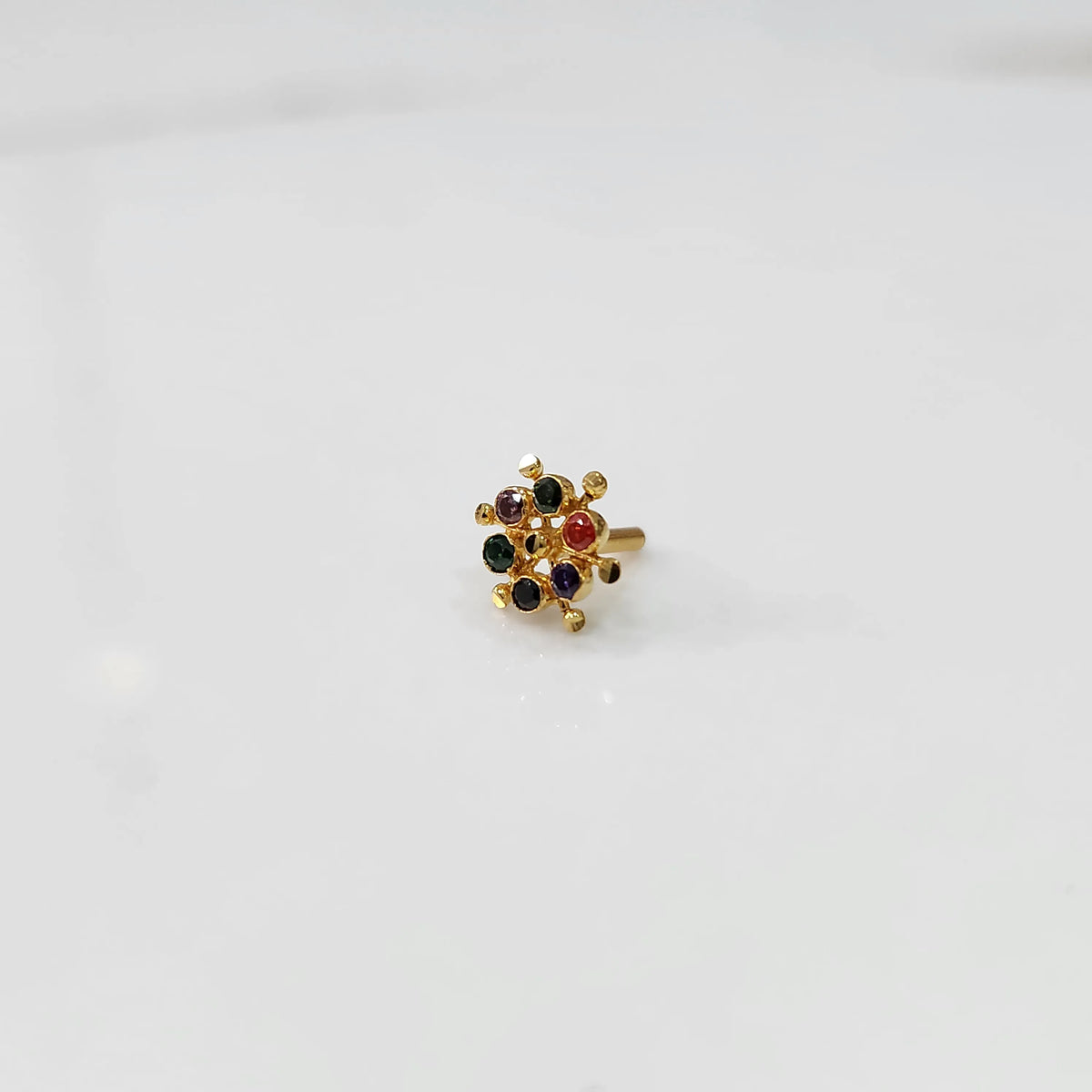 Gold statement ring with multicolor gemstones in scattered dotted cluster design