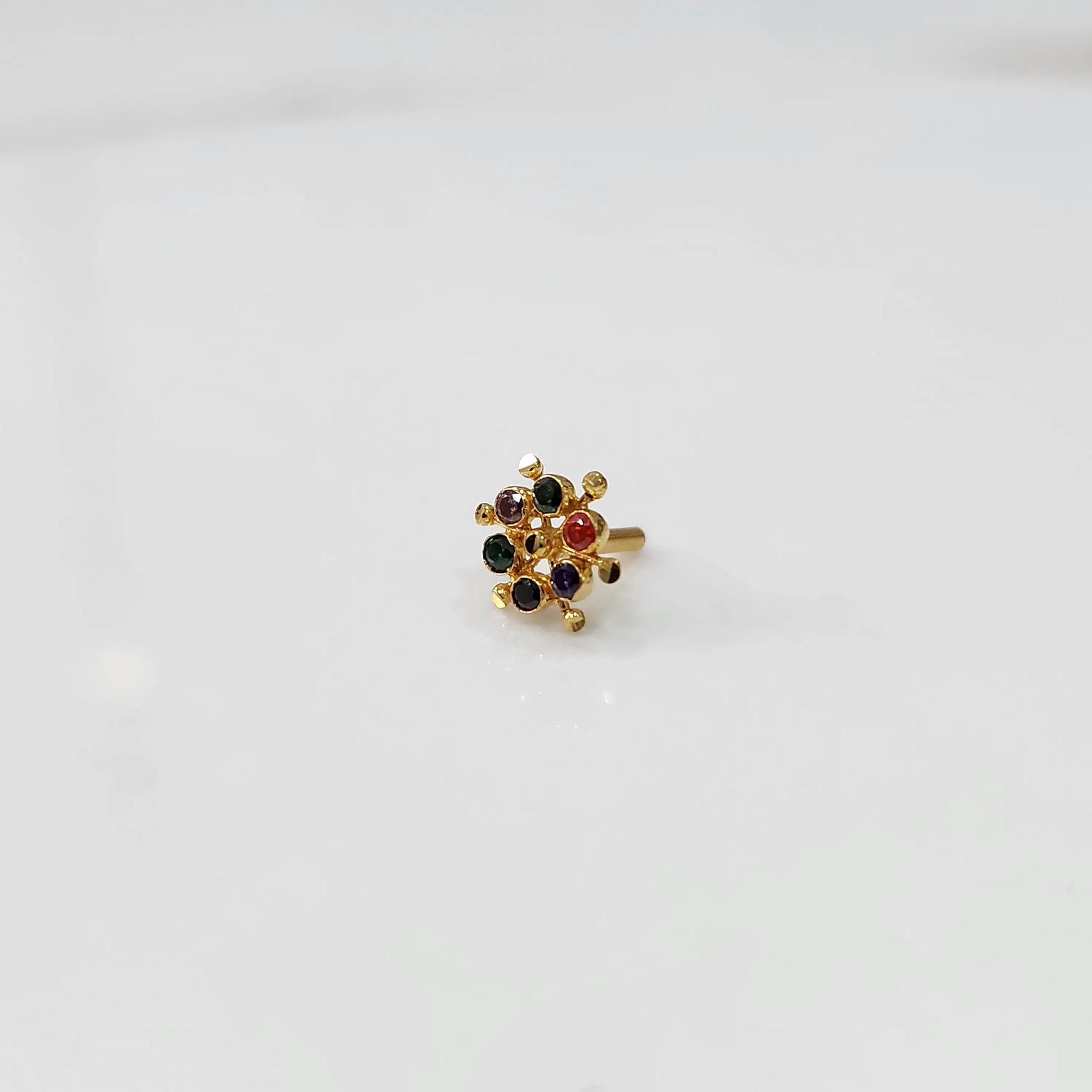 Gold statement ring with multicolor gemstones in scattered dotted cluster design