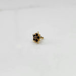 Side view nose pin design gold with black stone floral pattern on white background