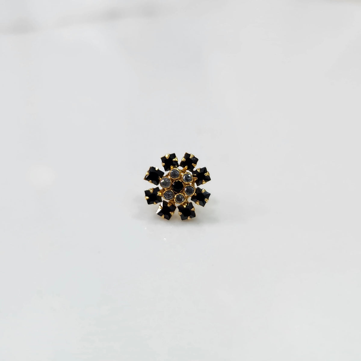 Gold nose pin with black square-cut stones and clear round center stones