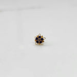 Gold nose pin with blue stones and champagne center in star-shaped petal borde