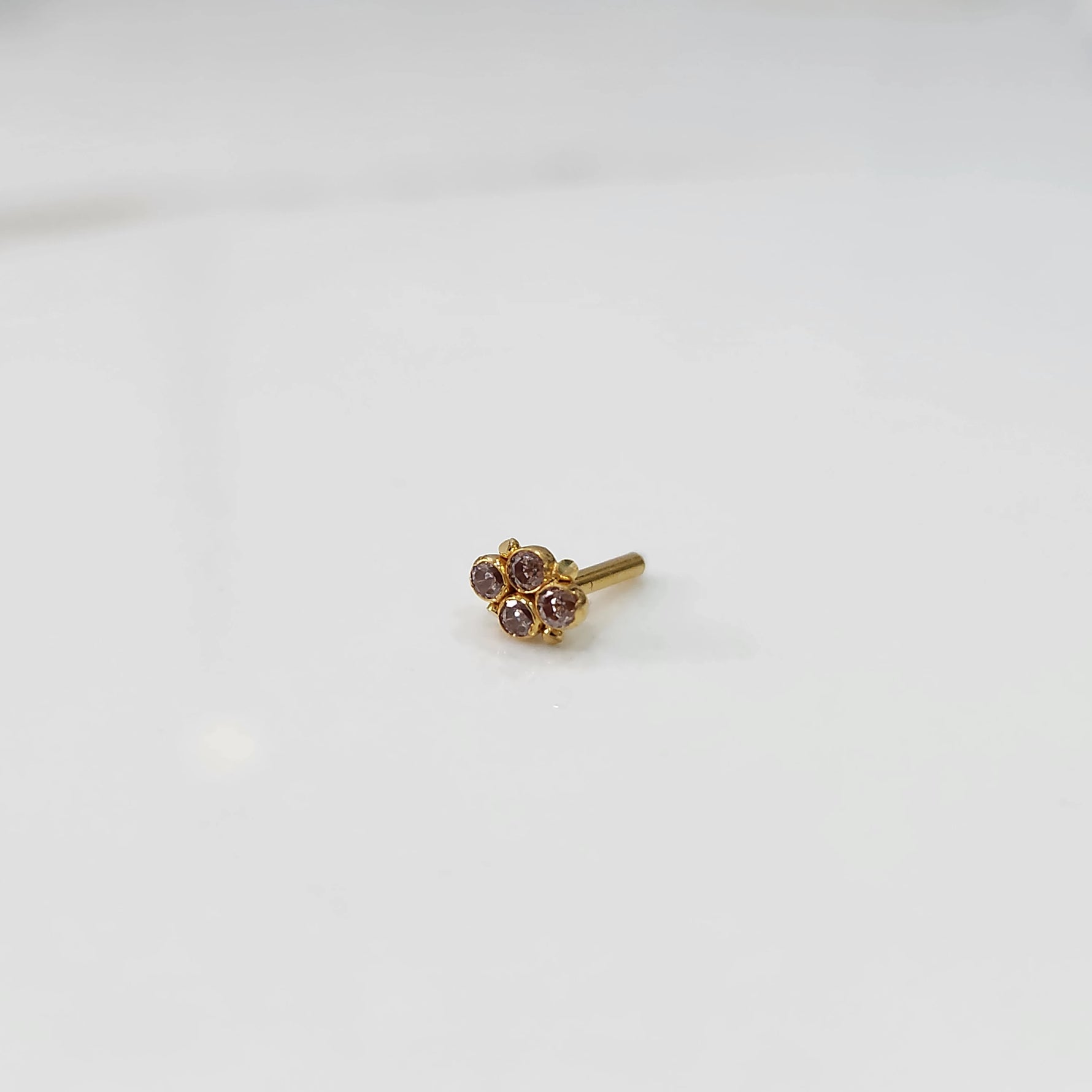 Gold nose pin with small all-champagne stone cluster