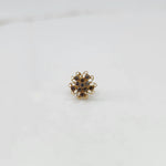 Gold nose pin with champagne round-cut stones and ornate swirl border