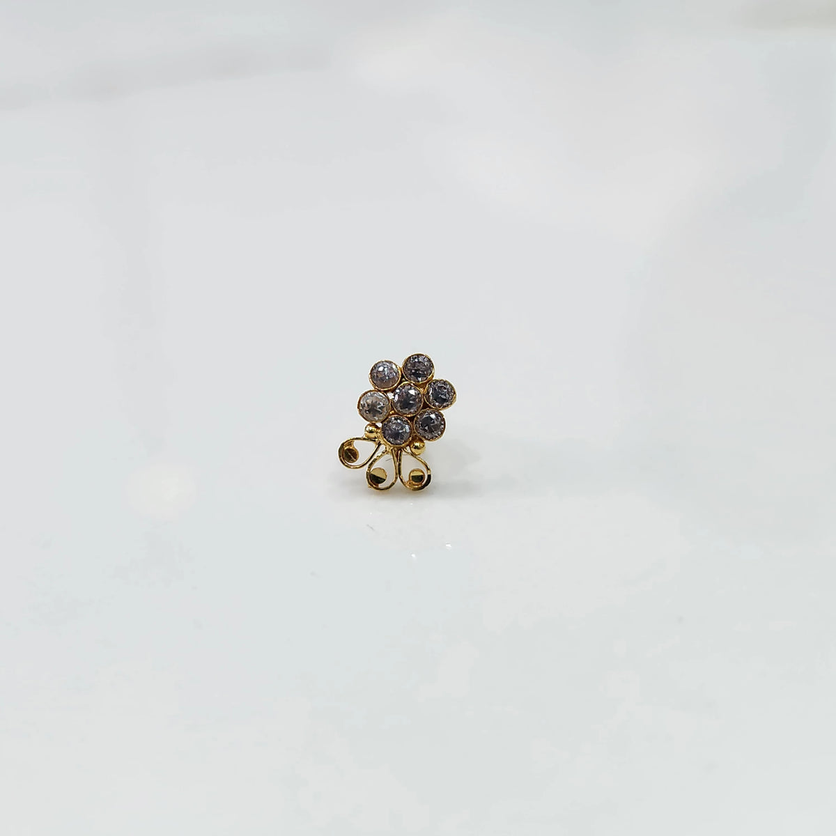 Gold nose pin with champagne stone cluster and curling swirl accent detail