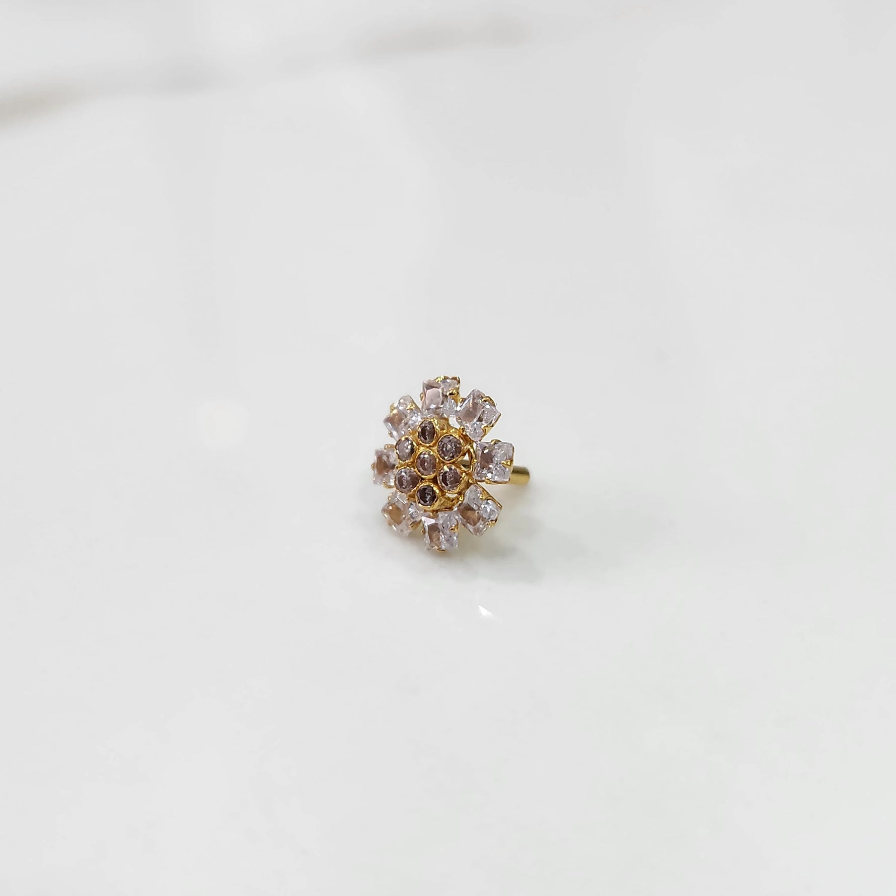 Gold nose pin with clear square-cut stones and champagne round center stones