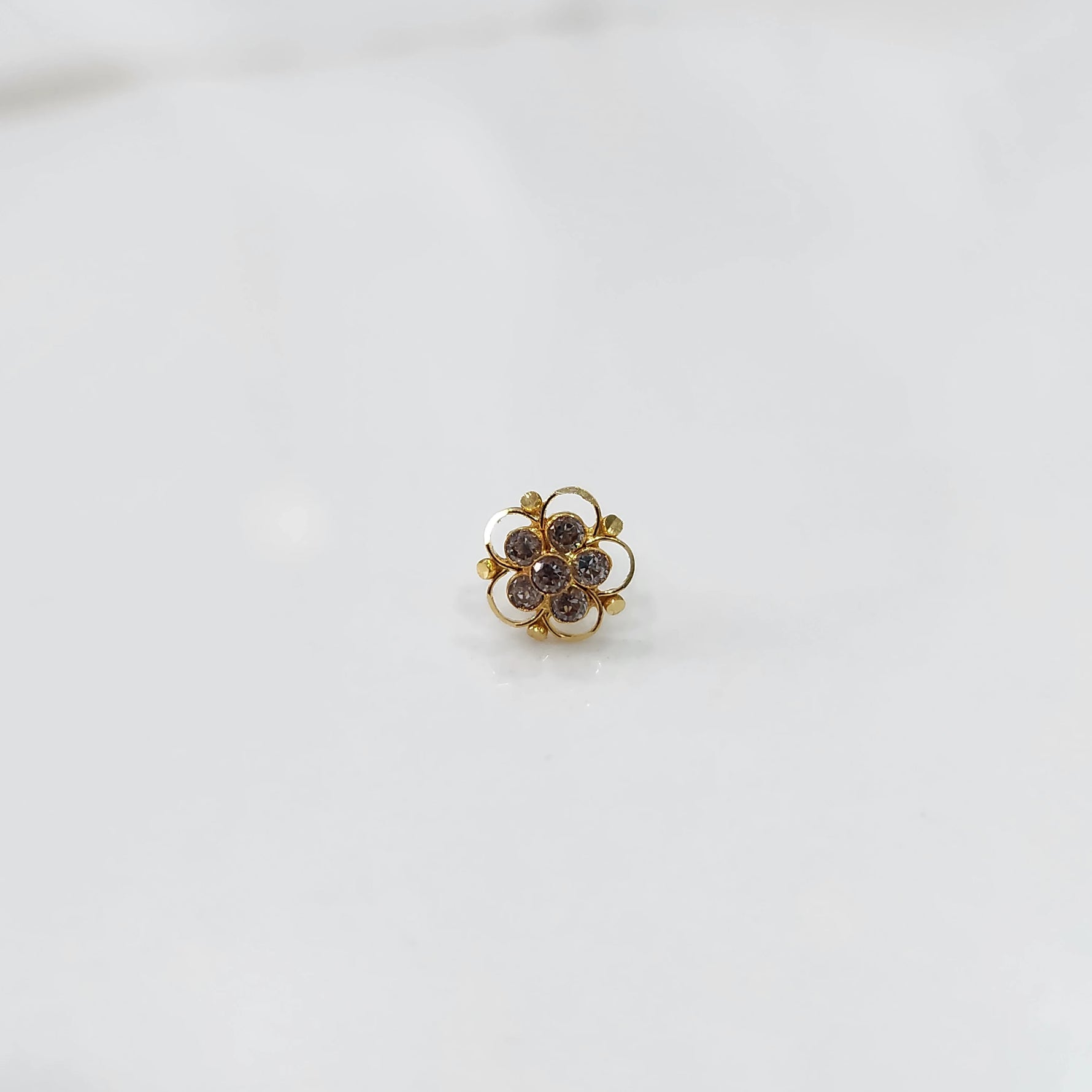 Gold floral nose pin with clear stone cluster