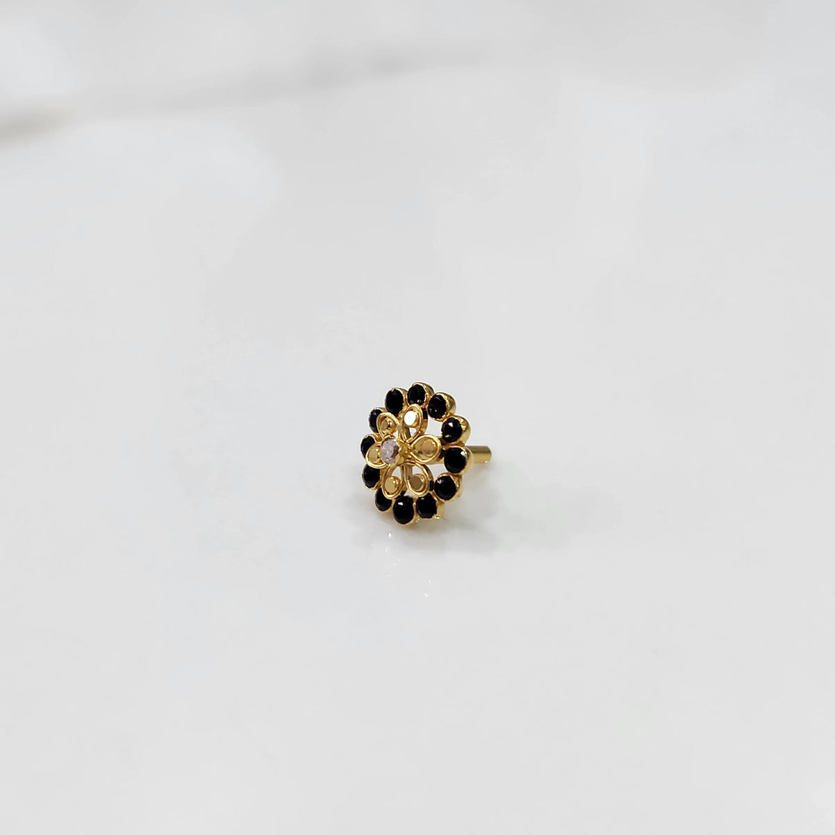 Gold nose pin design with circular floral diamond pattern